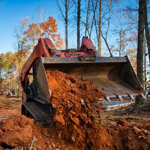 Land leveling after clearing trees and brush